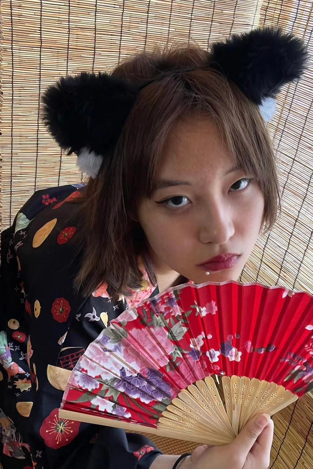 Portrait of Guo holding a floral fan